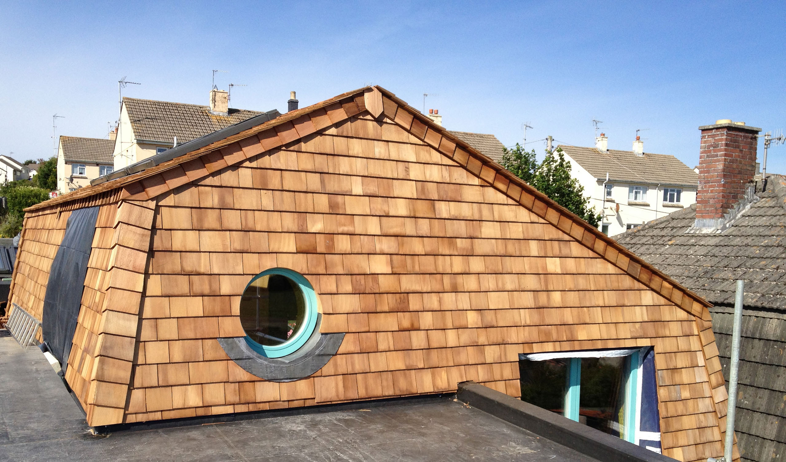 Wadebridge Responsive Home Roof Detail showing timber shingles on a mansard roof.